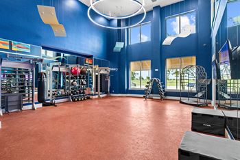 A gym with a red floor and blue walls.